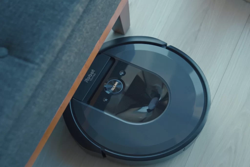 Roomba iRobot vacuum cleaner under the couch